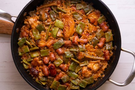 Photo for Traditional Spanish paella with sausage, green beans and artichokes. - Royalty Free Image