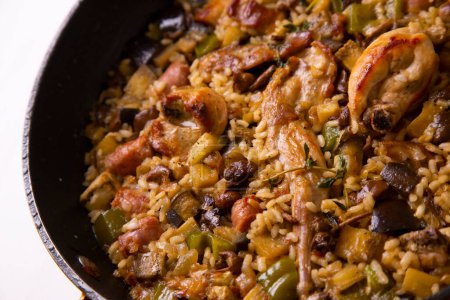 Photo for Traditional Spanish paella with rabbit and vegetables. - Royalty Free Image