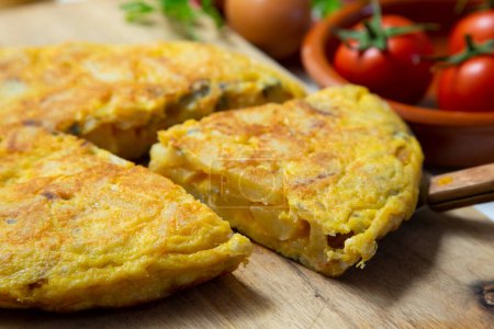 Photo for The potato omelette or Spanish omelette is an omelette or omelet to which chopped potatoes are added. It is one of the most well-known and emblematic dishes of Spanish cuisine. - Royalty Free Image