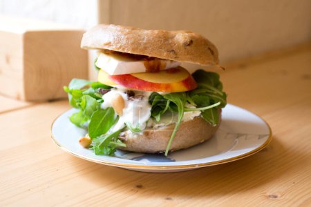 Téléchargez les photos : Délicieux sandwich aux pommes sur pain bagel. Un bagel est un pain traditionnellement fabriqué à partir de farine de blé et a généralement un trou au centre. - en image libre de droit
