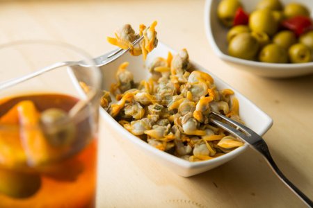 Photo for Vermouth is a wine macerated in herbs that is taken as an aperitif with cockles, anchovies, olives or mussels. - Royalty Free Image