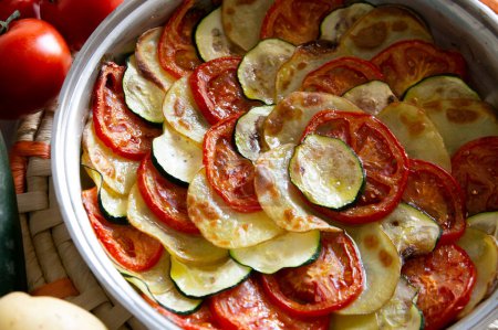 Photo for Vegetarian tart with potato, zucchini and tomato cut into slices - Royalty Free Image