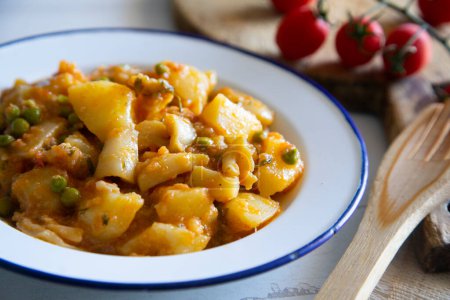 Photo for Stewed cuttlefish with potatoes. Traditional Spanish tapa recipe. - Royalty Free Image