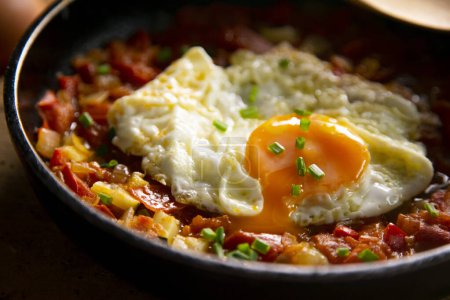 Photo for Manchego Pisto, also known simply as ratatouille, is a traditional dish from La Mancha that consists of a fry of various vegetables and egg - Royalty Free Image
