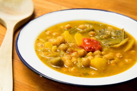 Typical Spanish dish of chickpea stew with vegetables such as carrots, peppers or zucchini.