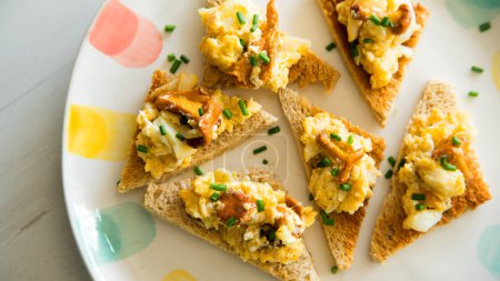 Photo for Scrambled with eggs and mushrooms on toasted bread. - Royalty Free Image