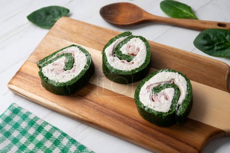 Photo for Spinach tortilla roll stuffed with ham and cream cheese. - Royalty Free Image