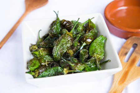 Photo for Fried green padron peppers. Traditional Spanish tapa. - Royalty Free Image
