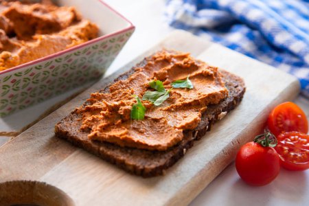 Photo for Toast with vegetarian pate made with dried tomato and other vegetables. - Royalty Free Image