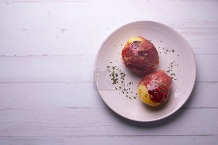 Photo for Boiled potatoes wrapped in serrano ham. Traditional Spanish tapa. - Royalty Free Image