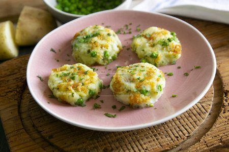 Photo for Salty fried polenta cakes with peas. - Royalty Free Image