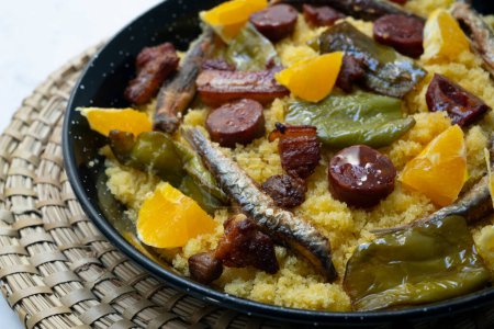 Photo for Spanish Migas tapa. Recipe with breadcrumbs, anchovies, chorizo and fried pepper. - Royalty Free Image