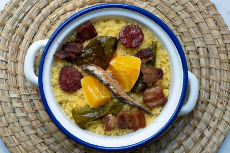 Photo for Spanish Migas tapa. Recipe with breadcrumbs, anchovies, chorizo and fried pepper. - Royalty Free Image