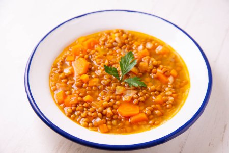 Photo for Lentil dish with potato, chorizo and black pudding. Traditional Spanish lentil stew with vegetables. - Royalty Free Image