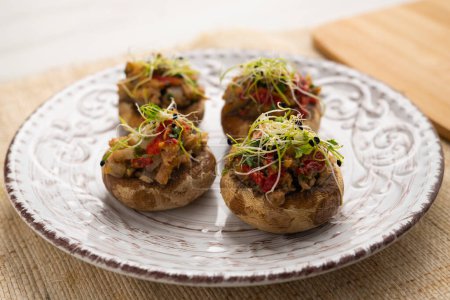Photo for Baked mushrooms stuffed with sobrassada and quail eggl. Traditional Spanish tapa. - Royalty Free Image
