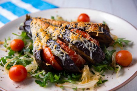 Photo for Baked eggplant stuffed with slices of cheese and tomato. - Royalty Free Image