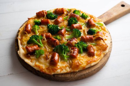 Photo for Neapolitan pizza with chistorra chorizo and broccoli. - Royalty Free Image