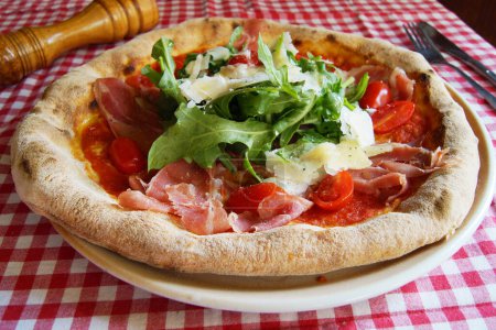 Photo for Serrano ham pizza. Neapolitan pizza made with baked vegetables and serrano ham. Italian vegetarian recipe. - Royalty Free Image
