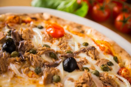 Photo for Tuna Pizza. Neapolitan pizza with mozzarella cheese, tuna, onion and olives. Authentic Italian recipe. - Royalty Free Image