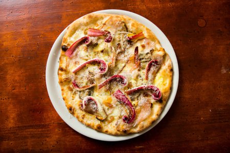 Photo for Neapolitan pizza with guanciale, pecorino and radicchio. Classic Italian recipe. - Royalty Free Image