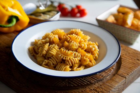 Photo for Pasta with sauted pumpkin, peppers and black olives. - Royalty Free Image