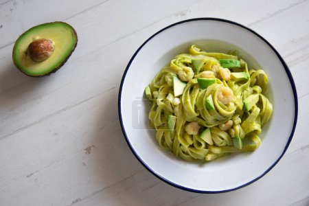 Photo for Italian pasta recipe with avocado sauce and prawns. - Royalty Free Image