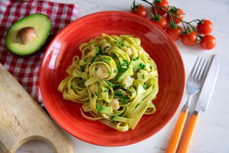 Photo for Italian pasta recipe with avocado sauce and prawns. - Royalty Free Image