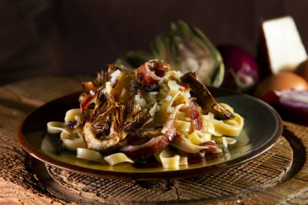 Photo for Italian pasta recipe with spaghetti, fried artichokes, and ham - Royalty Free Image