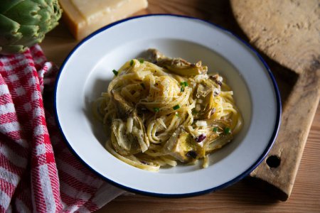 Photo for Italian pasta recipe with spaghetti, fried artichokes, and ham - Royalty Free Image