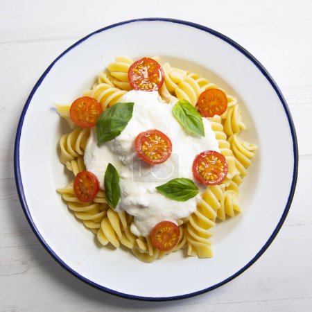 Photo for Italian fusilli pasta recipe with mozzarella sauce and cherry tomatoes - Royalty Free Image
