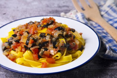 Photo for Pasta with tomato, black olives and capers. - Royalty Free Image
