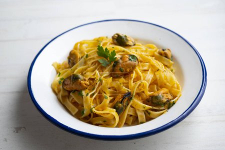 Photo for Noodles with mussels. Traditional Italian recipe. - Royalty Free Image