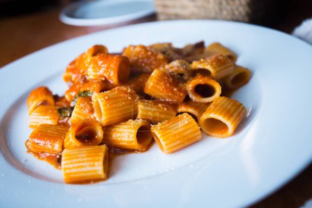 Photo for Pasta al pomodoro is an Italian meal typically prepared with pasta, olive oil, fresh tomatoes, basil, and other fresh ingredients. It is meant to be a quick and light dish, rather than a dish with a thick sauce. Pomodoro means "tomato" in Italian. - Royalty Free Image