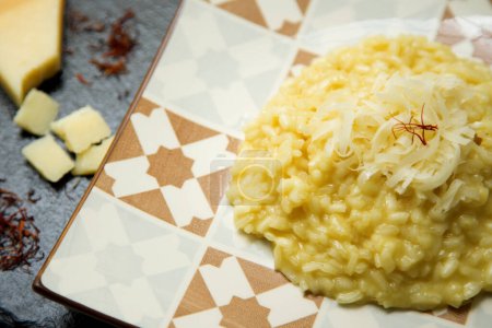 Photo for Italian risotto recipe with saffron and grana padano cheese - Royalty Free Image