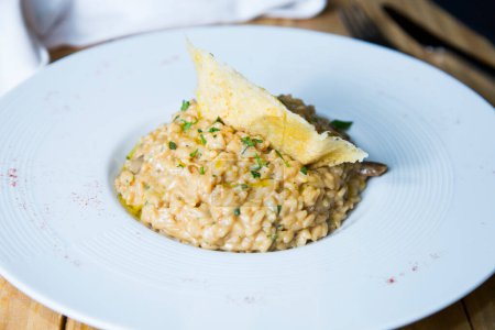 Téléchargez les photos : Risotto est un repas italien traditionnel préparé en ajoutant progressivement du bouillon au riz, ainsi que d'autres ingrédients qui varient selon les recettes de risotto spécifiques. - en image libre de droit