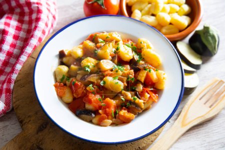 Photo for Gnocchis with vegetables as eggplant, zucchini, tomato...Gnocchi or gnocchi are a type of Italian pasta. They are made with potatoes, flour and ricotta cheese. - Royalty Free Image
