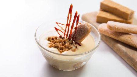 Téléchargez les photos : Tiramisu est un gâteau froid qui est assemblé en couches. Café, chocolat en poudre et mascarpone sont les principaux ingrédients de ce dessert italien. - en image libre de droit