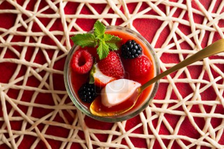 Photo for Panna cotta is a typical dessert from the Italian region of Piedmont, made from milk or cream, sugar and gelling agents, which is usually garnished with red fruit jams. - Royalty Free Image