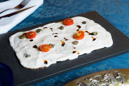 Photo for Vitel ton is a typical dish of Italian cuisine, from the Piedmont region. It is also very popular in Argentina. It is prepared with beef, accompanied by a sauce whose main ingredients are mayonnaise, tuna fillets, meat broth, anchovies and capers. - Royalty Free Image