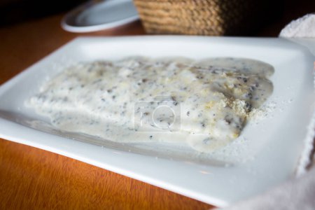 Photo for Vitel ton is a typical dish of Italian cuisine, from the Piedmont region. It is also very popular in Argentina. It is prepared with beef, accompanied by a sauce whose main ingredients are mayonnaise, tuna fillets, meat broth, anchovies and capers. - Royalty Free Image