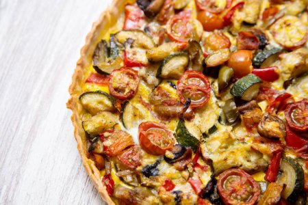 Photo for Vegetarian quiche. A quiche is a type of savory tart derived from the French quiche lorraine. It is made with a preparation of beaten eggs and thick fresh milk cream, mixed with chopped vegetables, and/or meat products. - Royalty Free Image