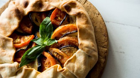 Photo for Eggplant and tomato galette. Galettes are a French specialty from Brittany. It is a variant of crpes in which buckwheat flour is used for the dough instead of durum wheat, and water. - Royalty Free Image