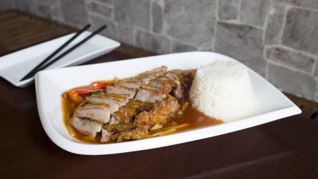                 Asian combo plate with roast duck and rice.               