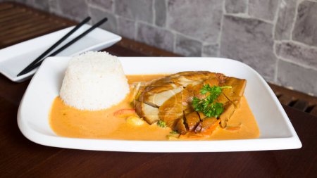 Photo for Asian combo plate with chicken in curry sauce and vegetables served with rice. - Royalty Free Image