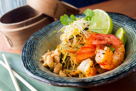 Photo for Pad thai, pad thai or pad thai, is a stir-fried rice noodle dish often served as street food in Thailand as part of the country's cuisine. - Royalty Free Image