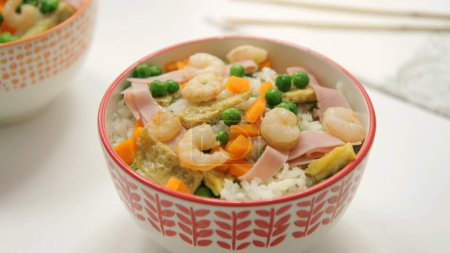 Photo for Fried rice three delicacies with prawns, peas, omelette and other vegetables. - Royalty Free Image