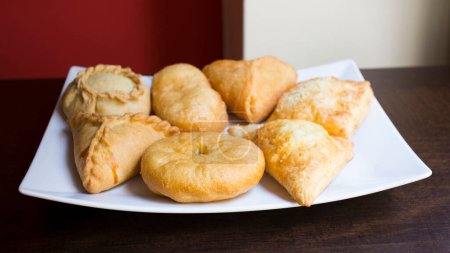 Photo for Pirozhki are stuffed rolls typical of Russian, Belarusian, and Ukrainian cuisines. They can be baked or fried with yeast. Their fillings are made of meat or vegetables. - Royalty Free Image