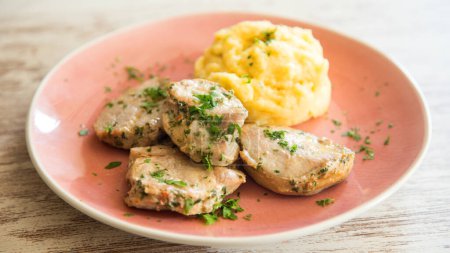 Photo for Top quality pork tenderloin served smashed potatoes. - Royalty Free Image