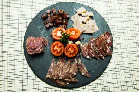 Photo for Tapa with a selection of sausages and top quality Iberico cheese such as ham, salchichn and Manchego cheese. - Royalty Free Image