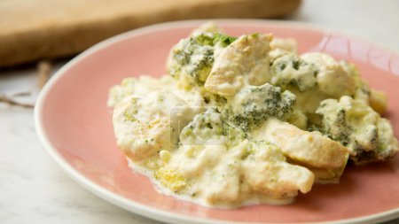 Photo for Baked chicken cooked with cream sauce and broccoli. - Royalty Free Image